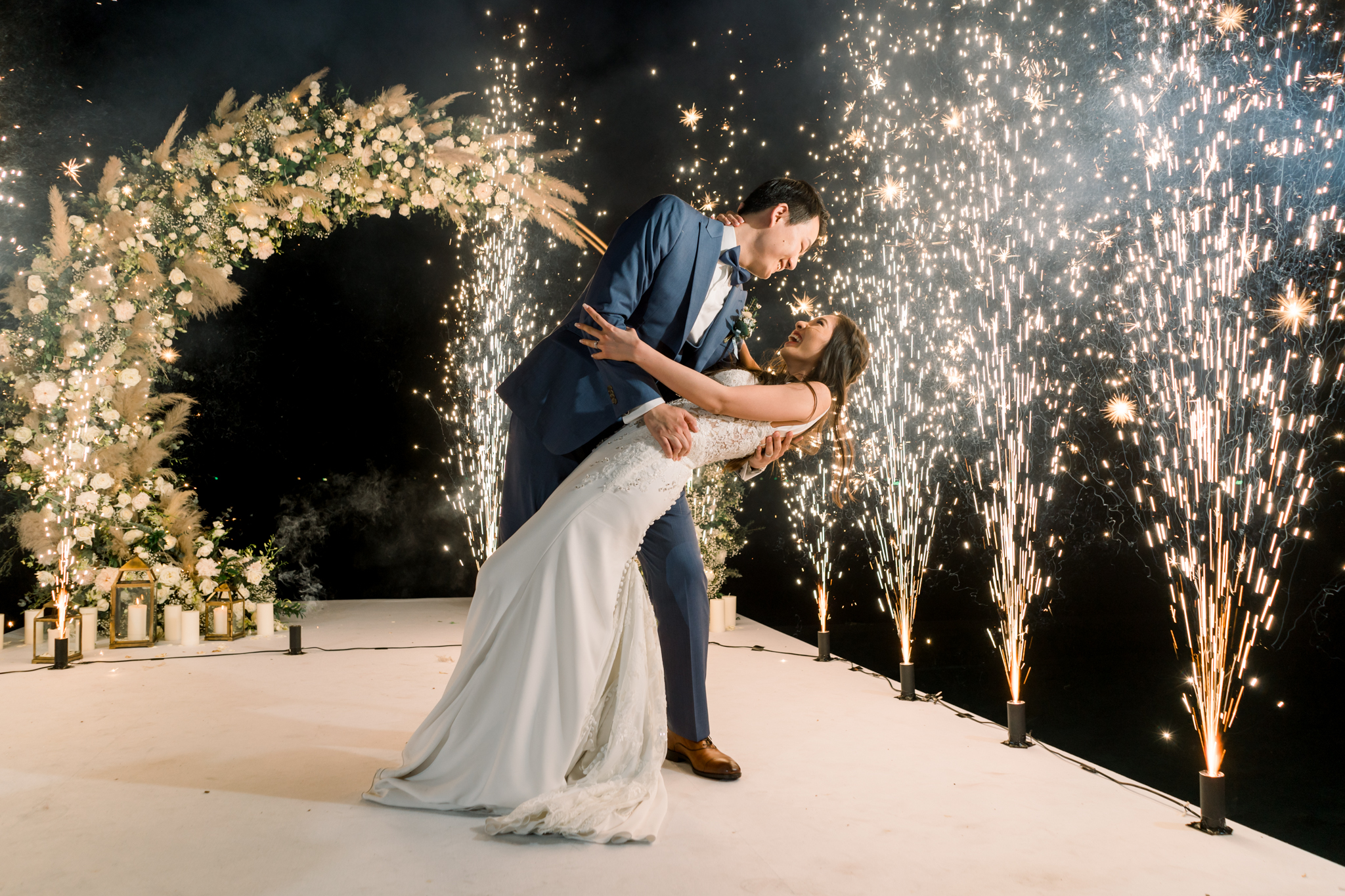 Eunice dipped in Ryan's arms surrounded by ground fireworks and cold sparks during the reception dance