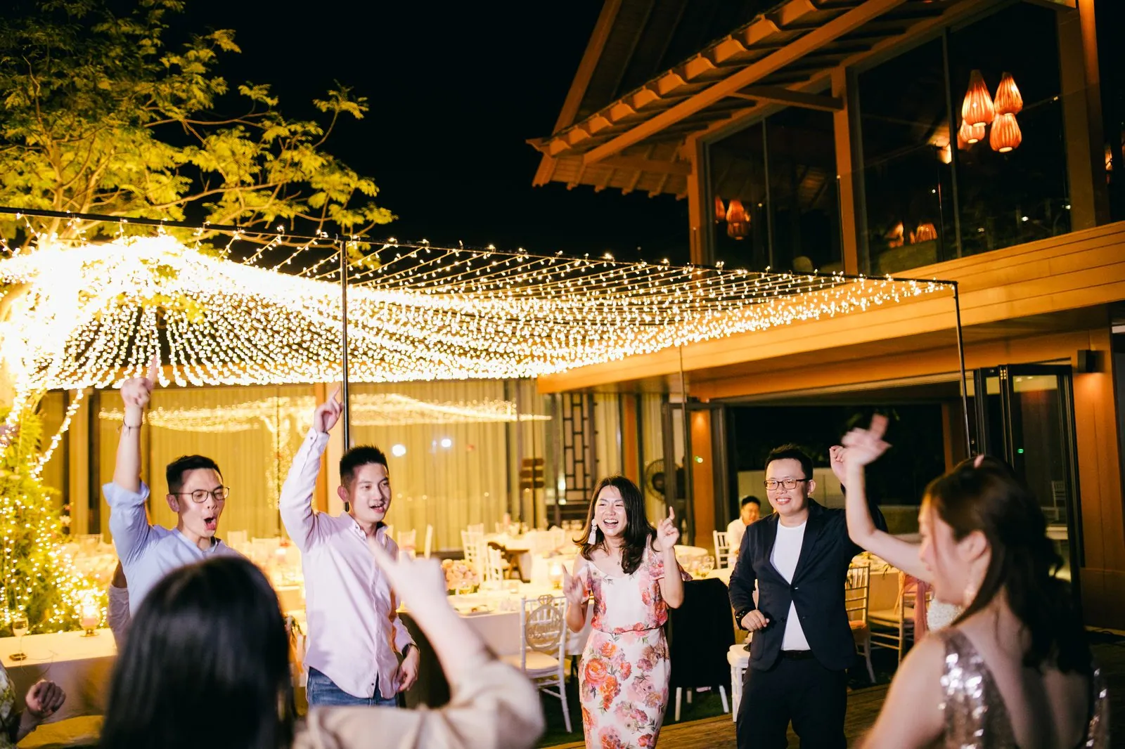 Villa Santisuk — evening reception under lights on the pool terrace
