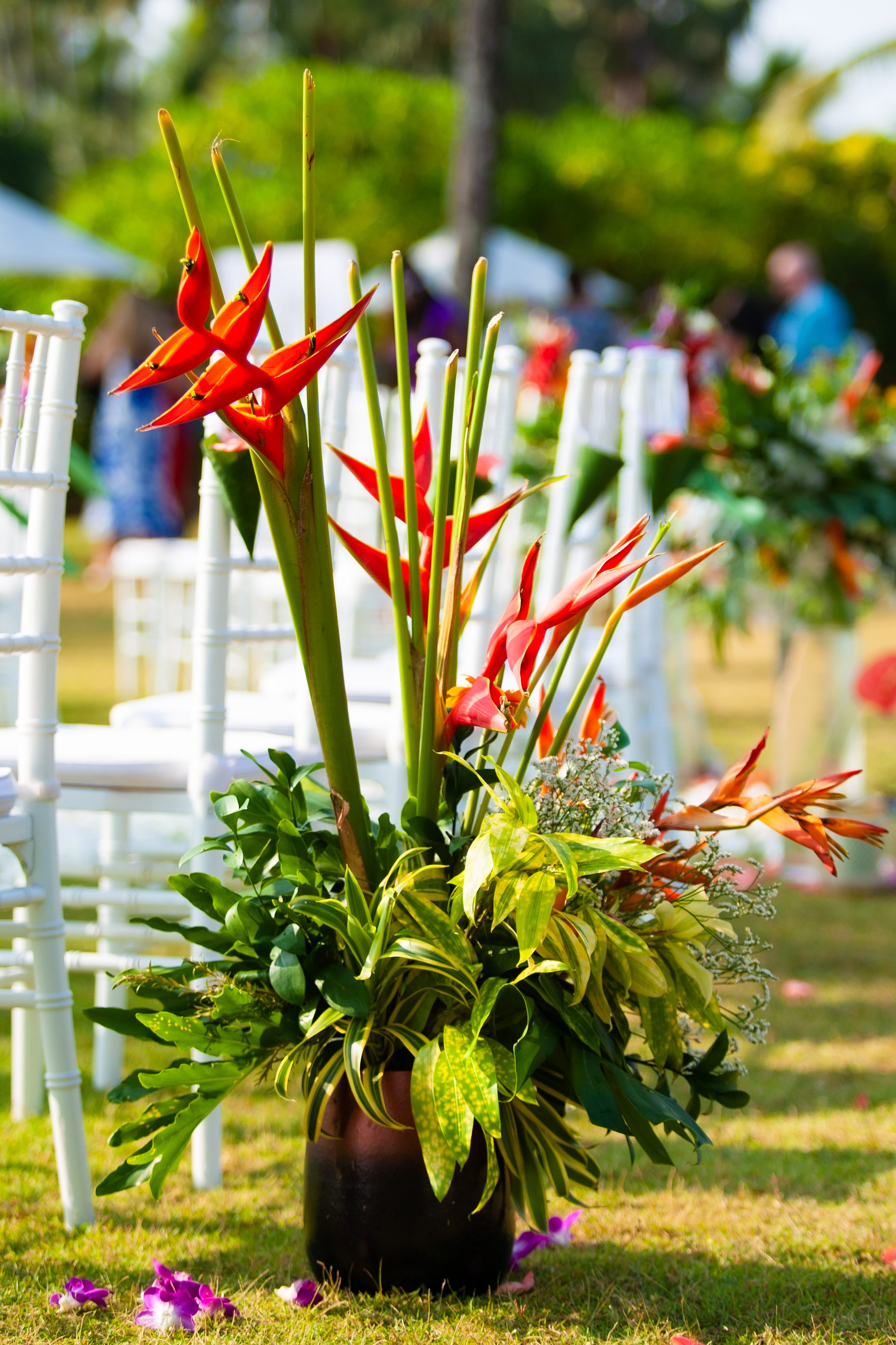 Tropical heliconia and orchid florals at Villa Jia for Bekki and Glen's beachfront ceremony
