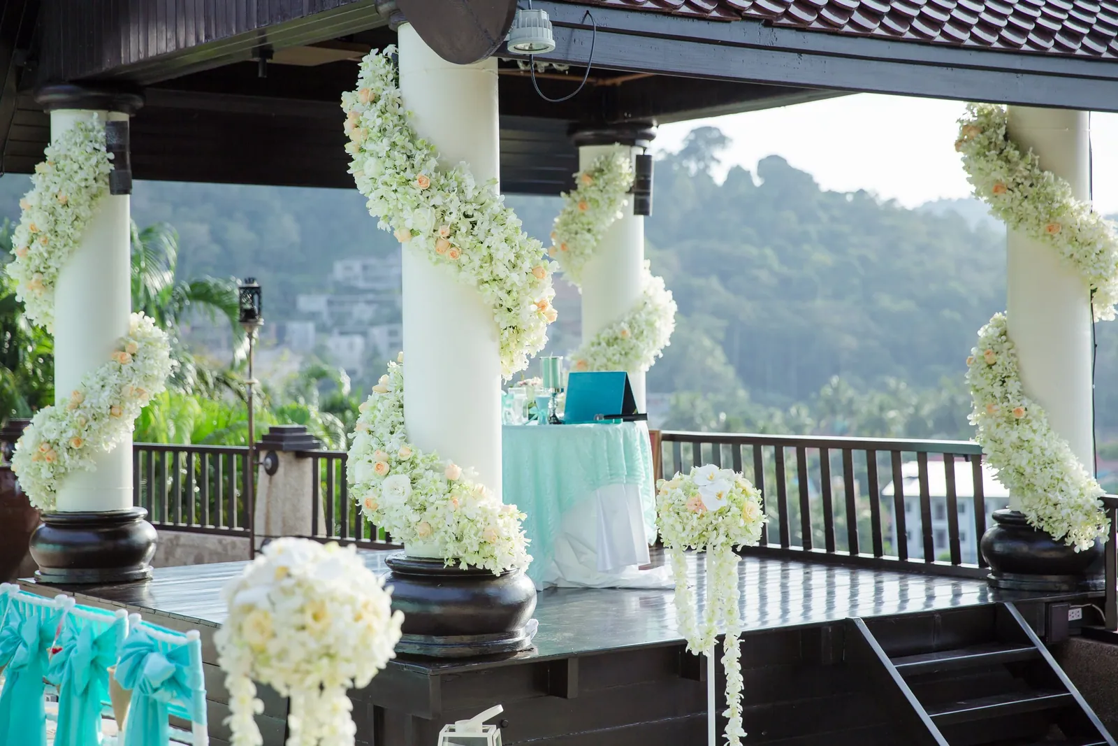 The sala on the upper terrace at Villa Baan Chang Thai, dressed with white flowers and mint accents for a ceremony