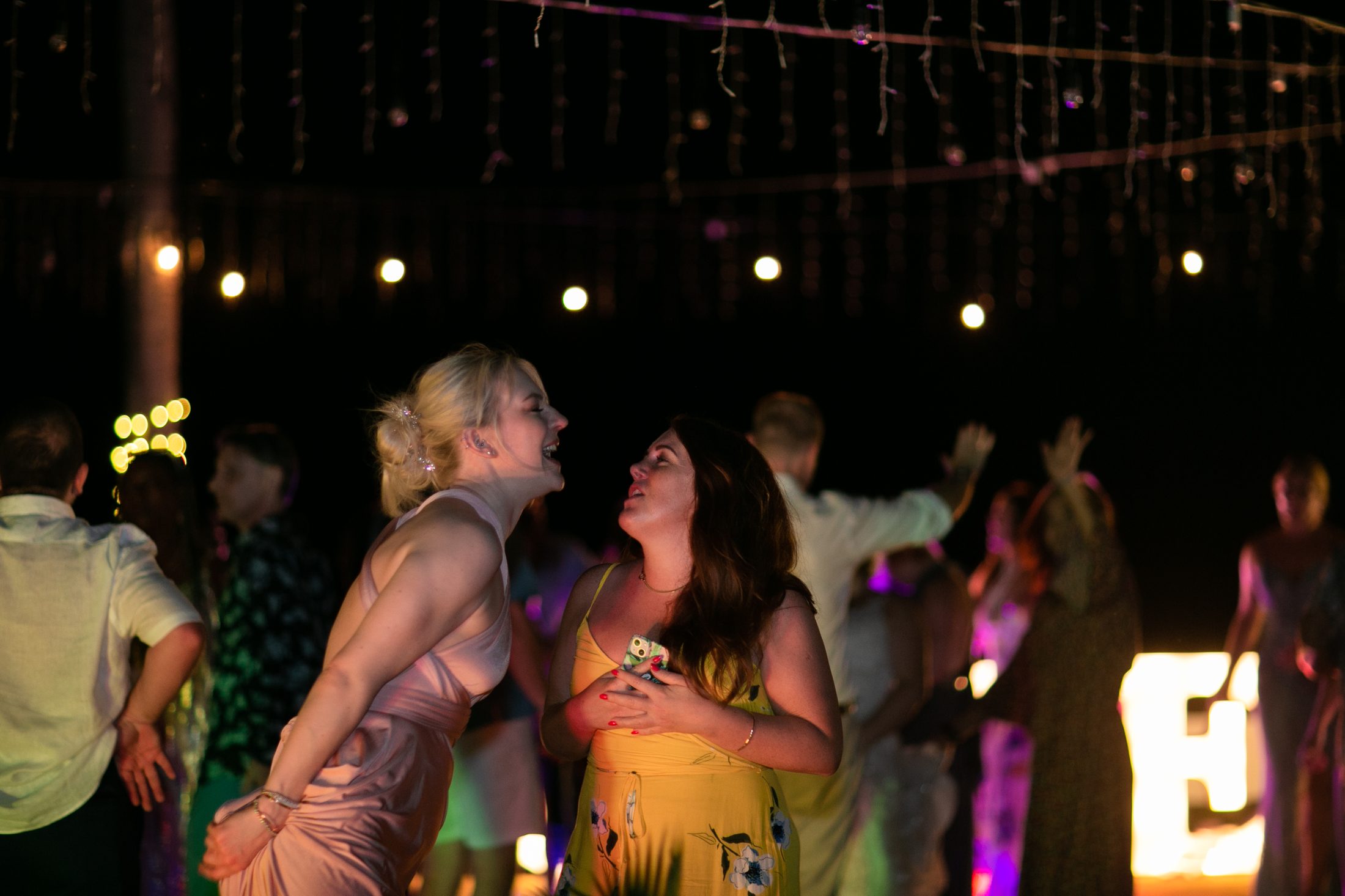 Guests dancing under the fairy lights at Bekki and Glen's Villa Jia reception