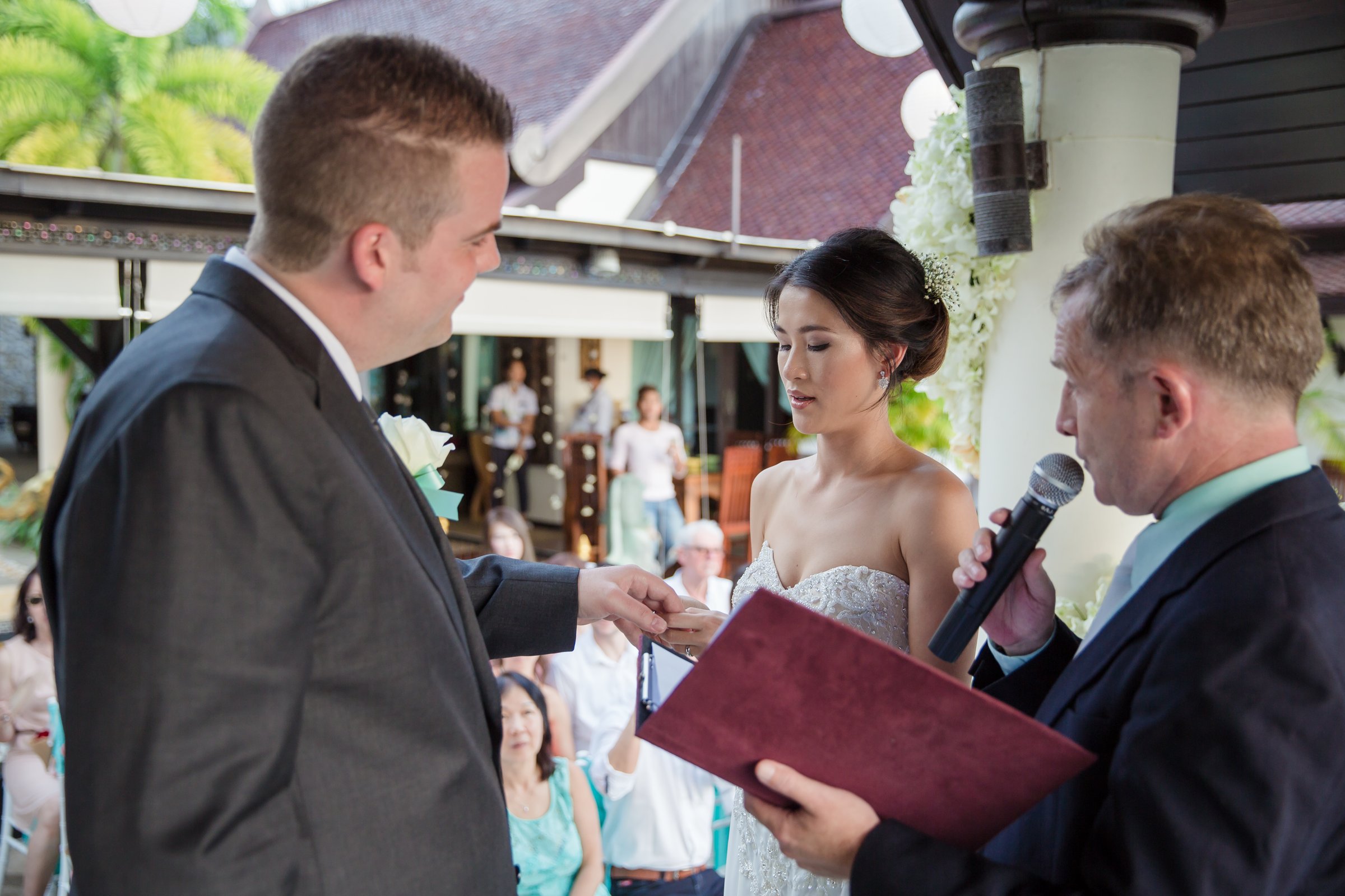 A ceremony under the floral arch on the terrace at Villa Baan Chang Thai