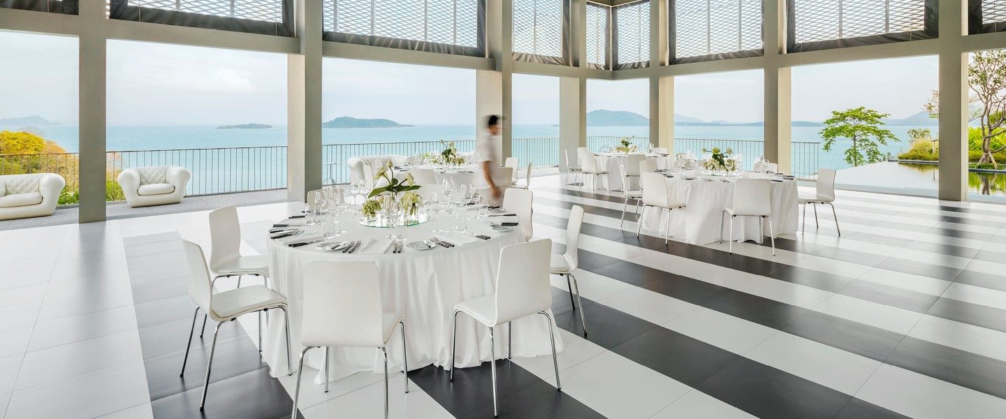 COMO Point Yamu — Sirena restaurant terrace laid for a wedding reception, with Phang Nga Bay in the distance