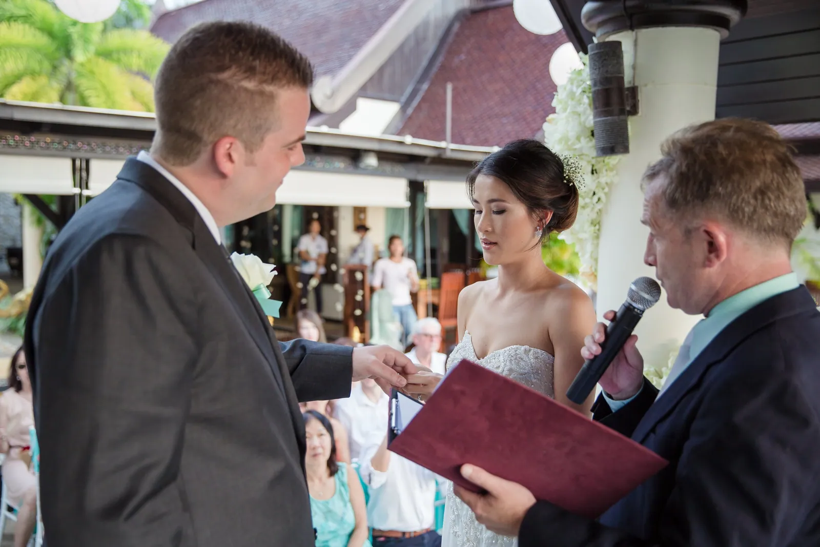 A ceremony under the floral arch on the terrace at Villa Baan Chang Thai