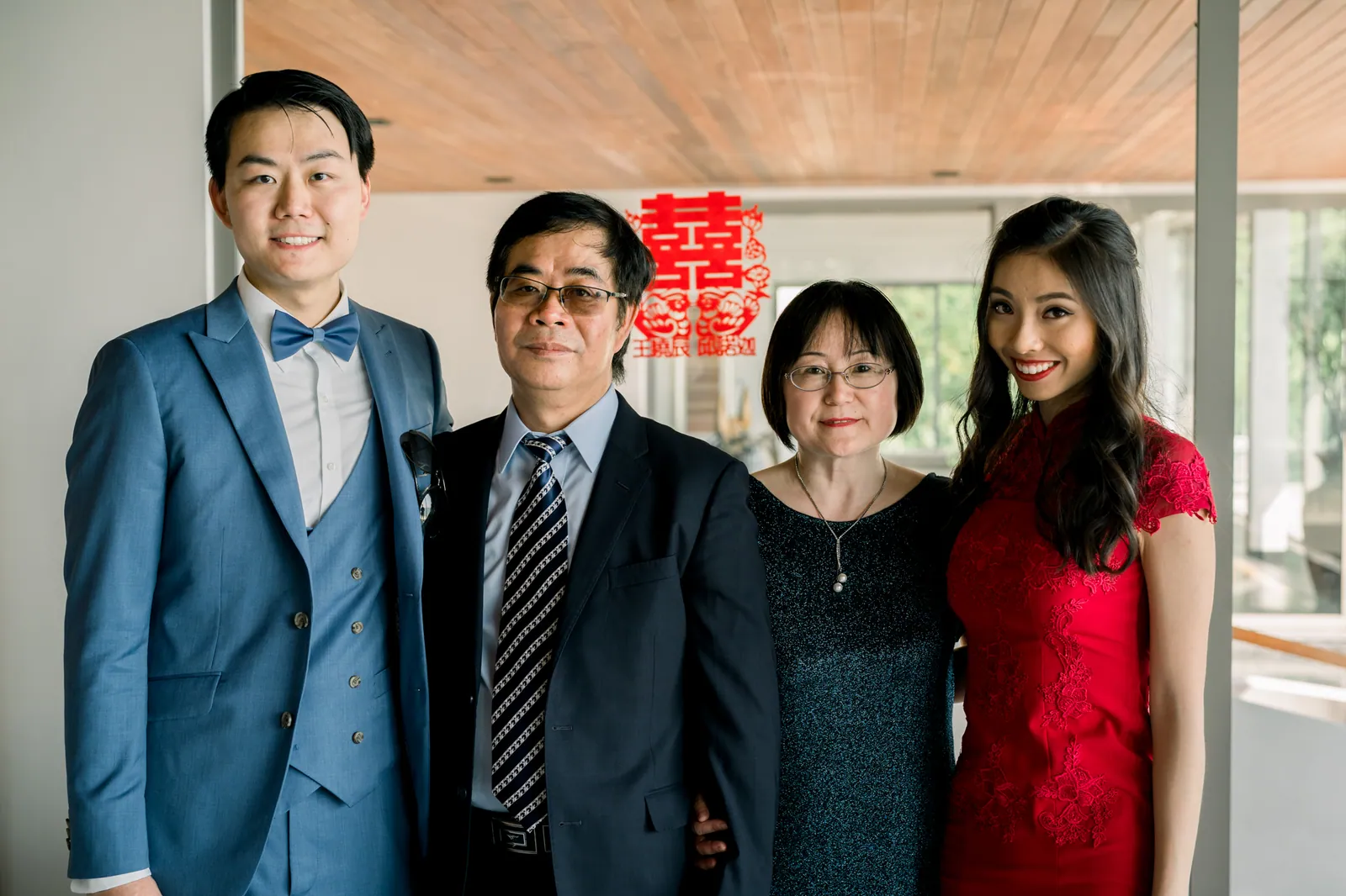 Ryan, Eunice and her parents beside the double-happiness character at the Chinese tea ceremony