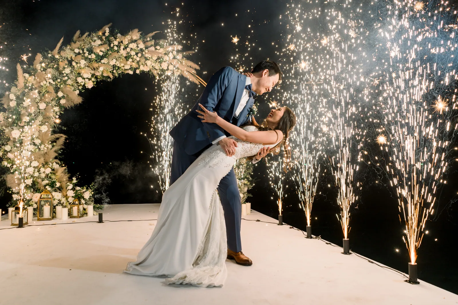 Eunice dipped in Ryan's arms surrounded by ground fireworks and cold sparks during the reception dance