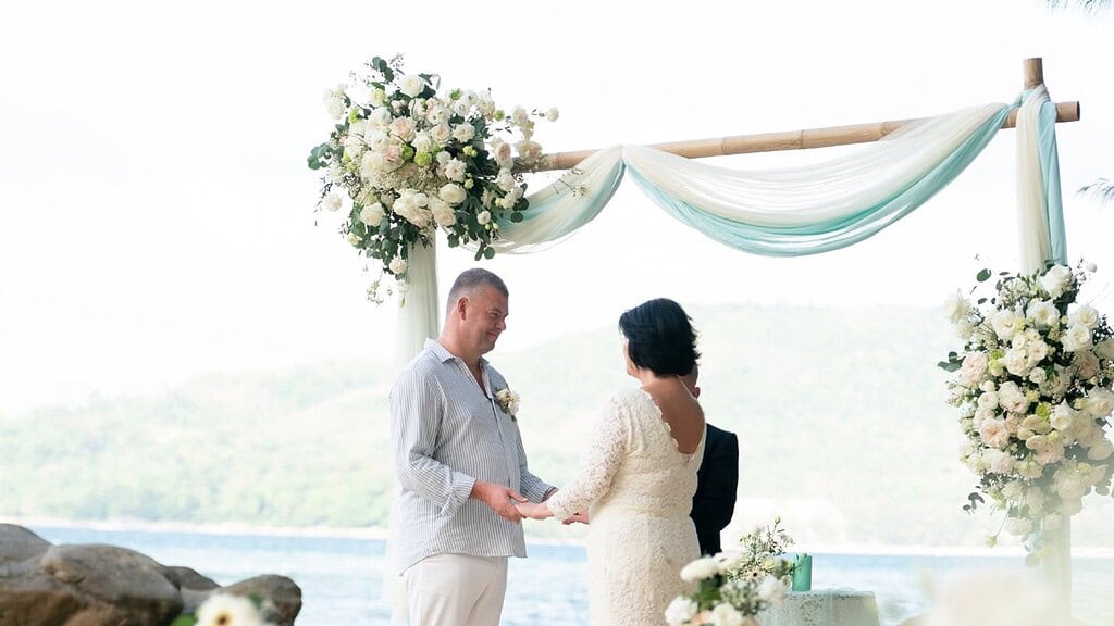 Wedding vow renewal - ceremony on a private Phuket beach with floral arch